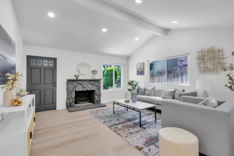 a living room with furniture a rug and a window