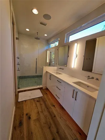 a bathroom with a double vanity sink and a mirror