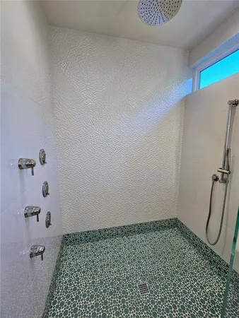 a bathroom with a sink mirror and tub