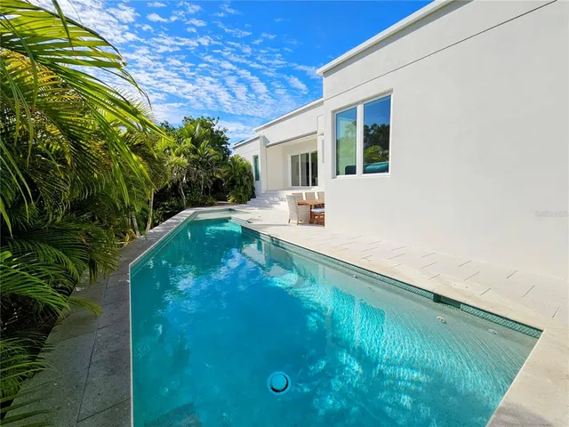 a bathroom with a sink a toilet a mirror and shower