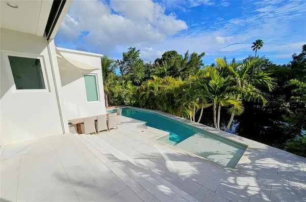 a large bed sitting in a bedroom next to a window