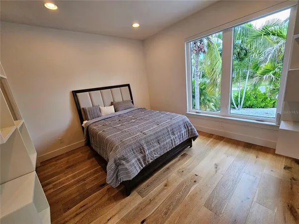 a bedroom with two beds and a window