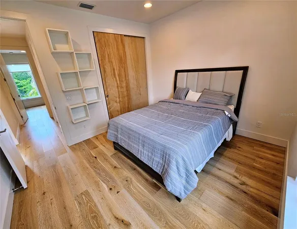 a bedroom with two beds and a closet