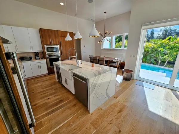 a living room with dining room and wooden floor
