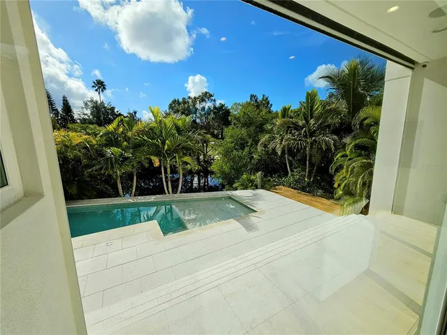 a view of a utility room with stainless steel appliances wooden floor and chair