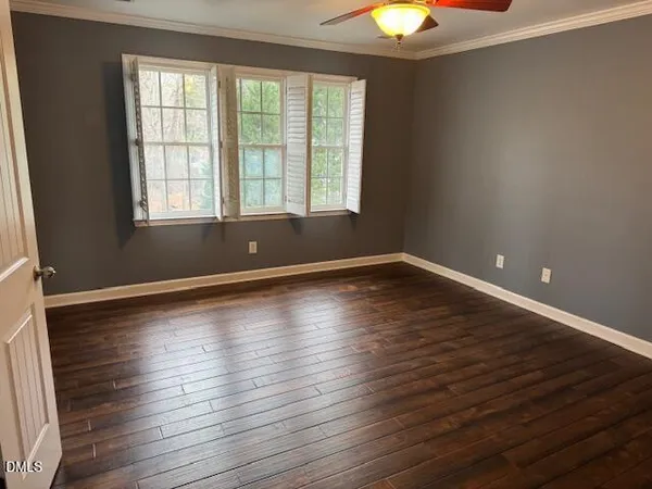 a view of room with window and wooden floor