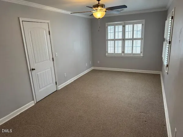 an empty room with windows and entrance
