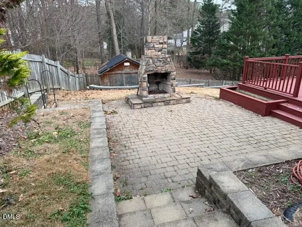 a view of a house with a wooden deck and a yard