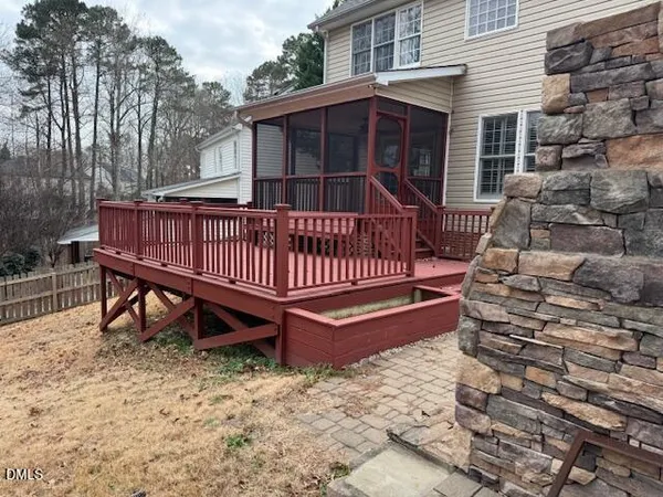 a view of a tiny house with a wooden fence