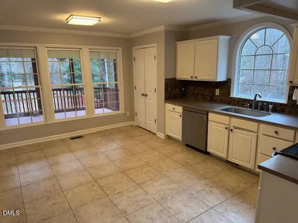 a view of a kitchen with stainless steel appliances granite countertop a stove a sink and a microwave