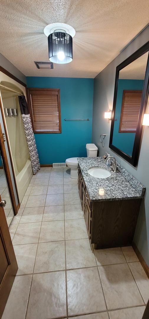 312 West Grove Road Sterling, IL 61081 - Photo 11 of 43 a bedroom with a bed and a mirror