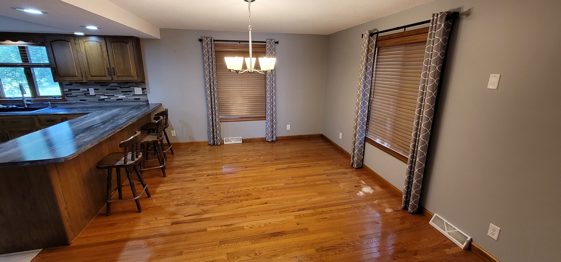 312 West Grove Road Sterling, IL 61081 - Photo 13 of 43 an empty room with wooden floor and windows