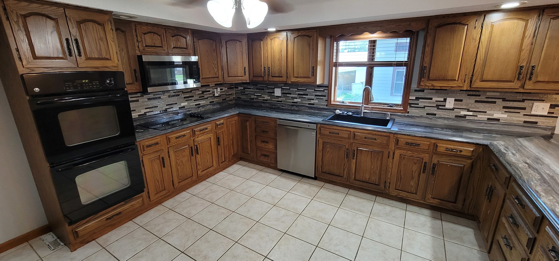 312 West Grove Road Sterling, IL 61081 - Photo 14 of 43 a kitchen with stainless steel appliances granite countertop a stove sink and cabinets