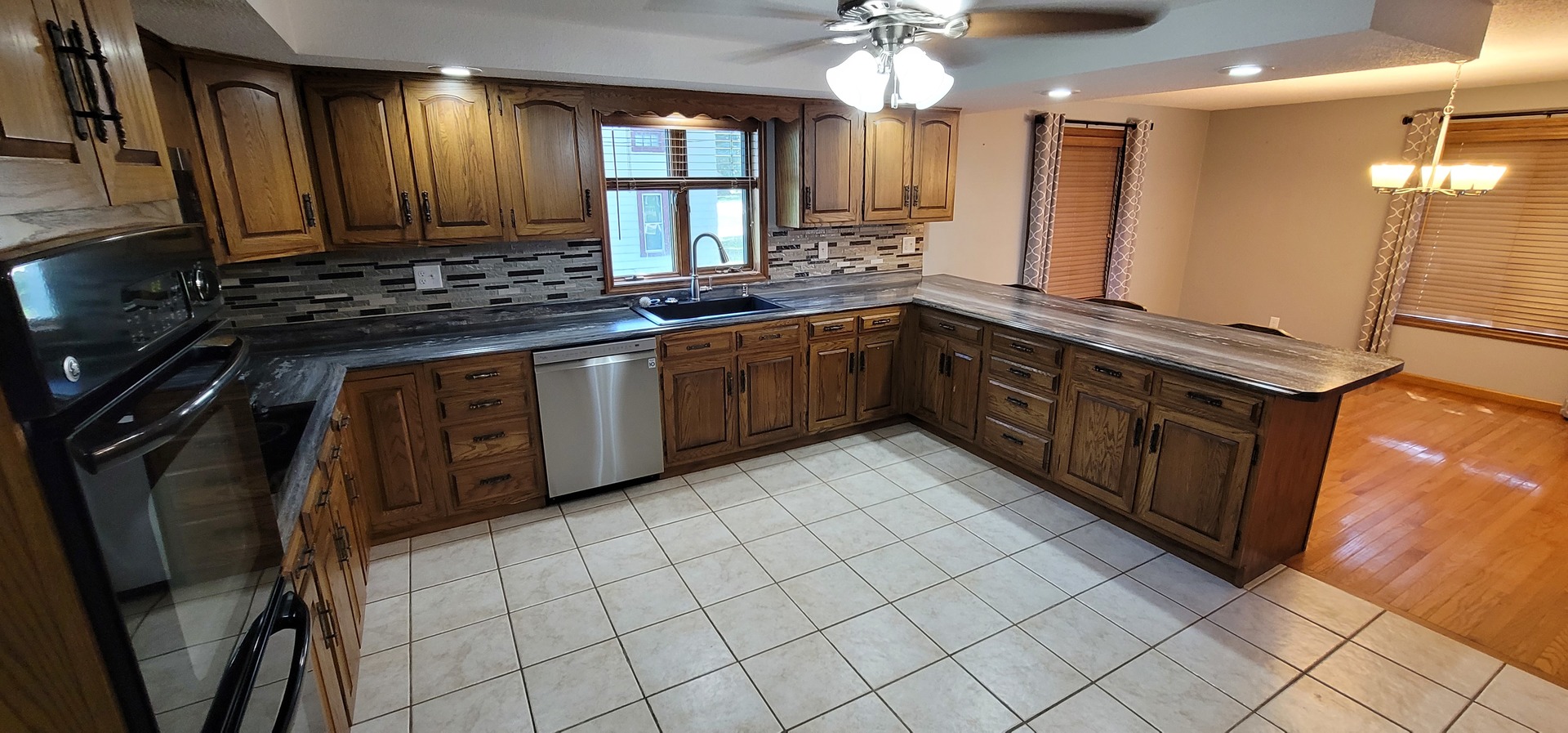 312 West Grove Road Sterling, IL 61081 - Photo 15 of 43 a kitchen with stainless steel appliances a sink stove and cabinets