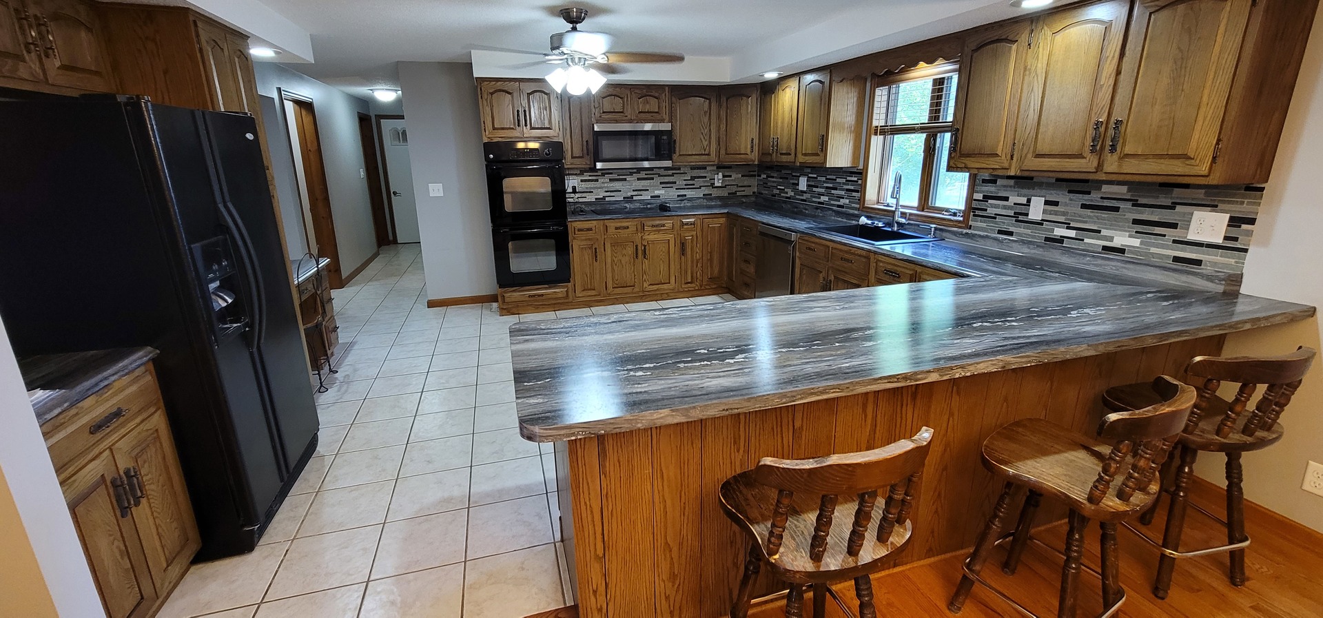 312 West Grove Road Sterling, IL 61081 - Photo 17 of 43 a kitchen with stainless steel appliances granite countertop a sink refrigerator and microwave