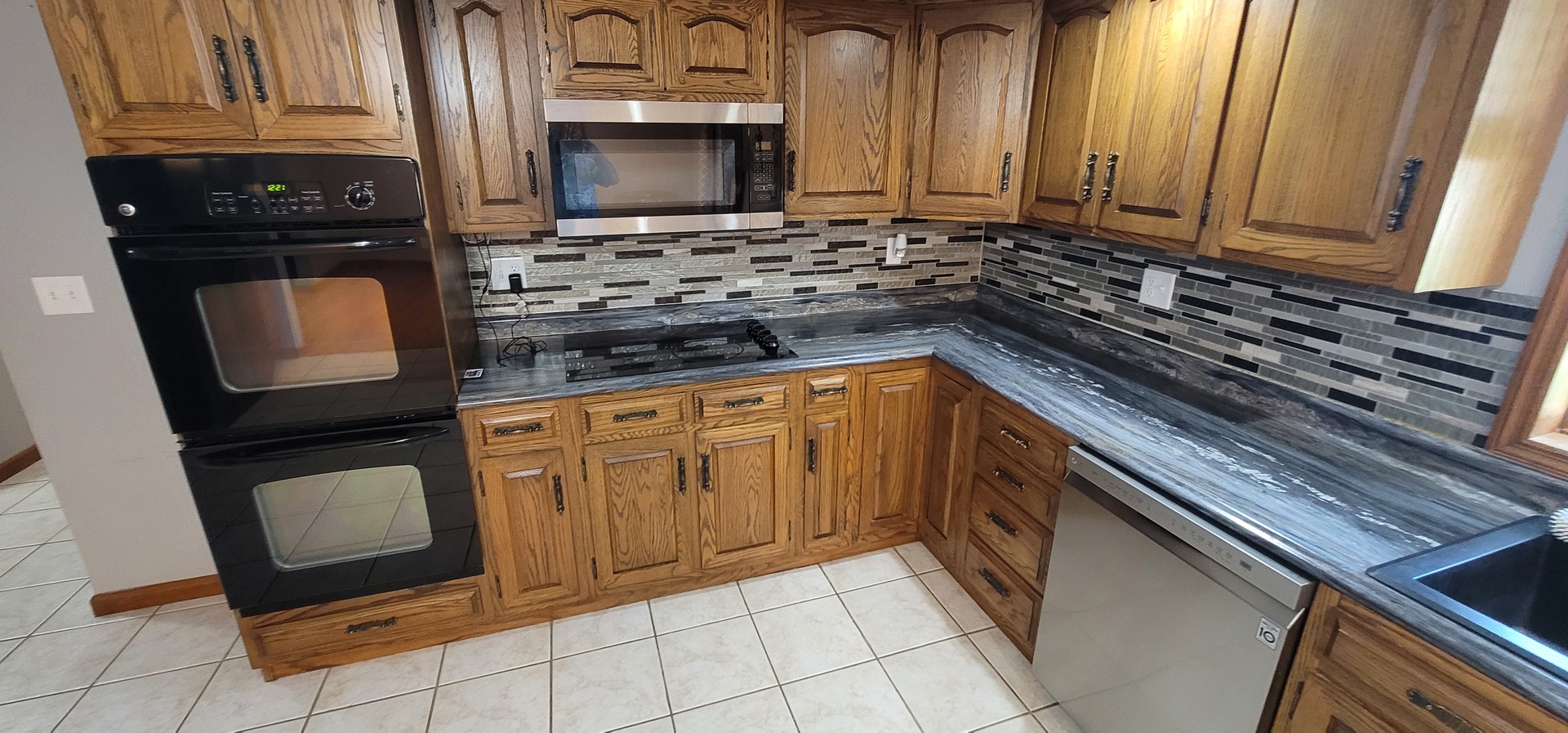 312 West Grove Road Sterling, IL 61081 - Photo 18 of 43 a kitchen with stainless steel appliances granite countertop a stove microwave and sink