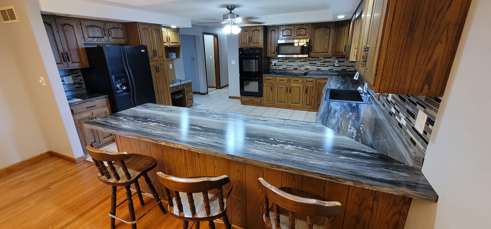 312 West Grove Road Sterling, IL 61081 - Photo 19 of 43 a kitchen with stainless steel appliances granite countertop table chairs and a refrigerator