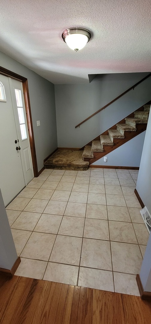 312 West Grove Road Sterling, IL 61081 - Photo 6 of 43 a view of a livingroom with an empty space and window