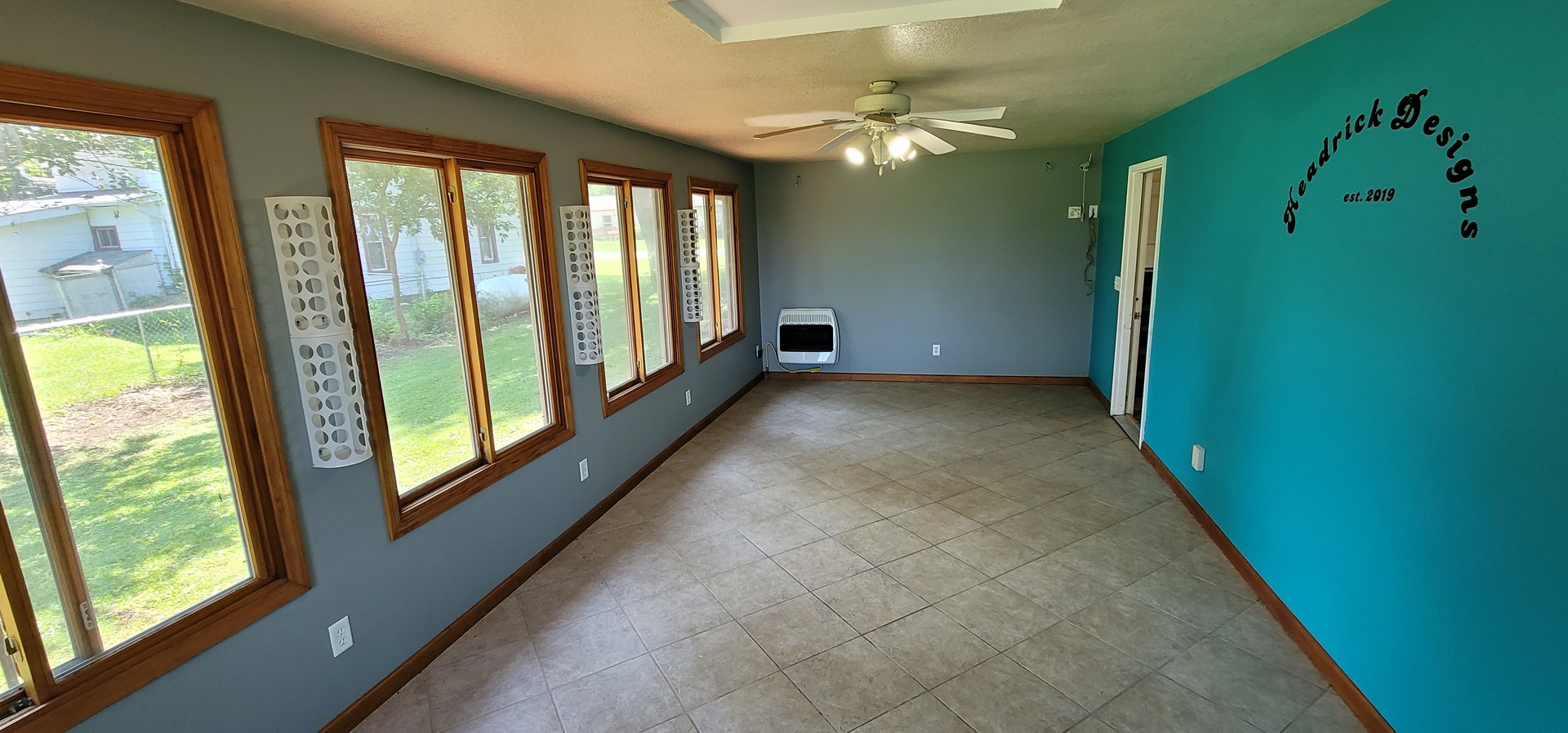 312 West Grove Road Sterling, IL 61081 - Photo 7 of 43 a view of a livingroom with an empty space and a large window