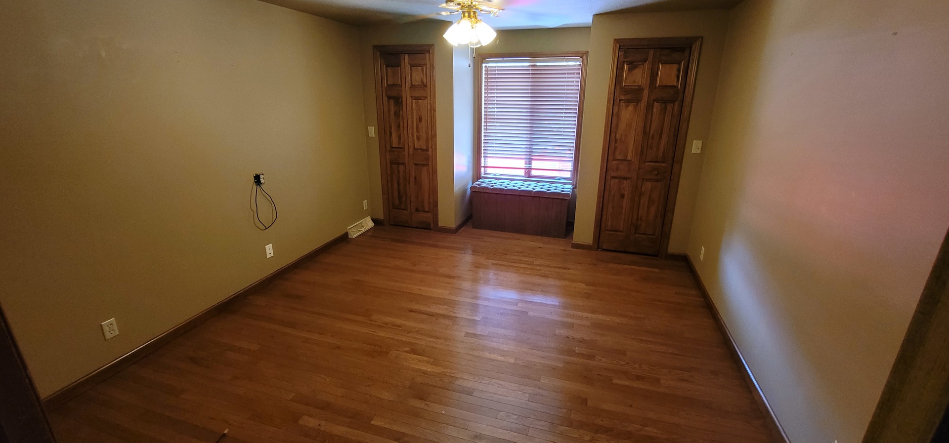 312 West Grove Road Sterling, IL 61081 - Photo 10 of 43 an empty room with wooden floor and windows