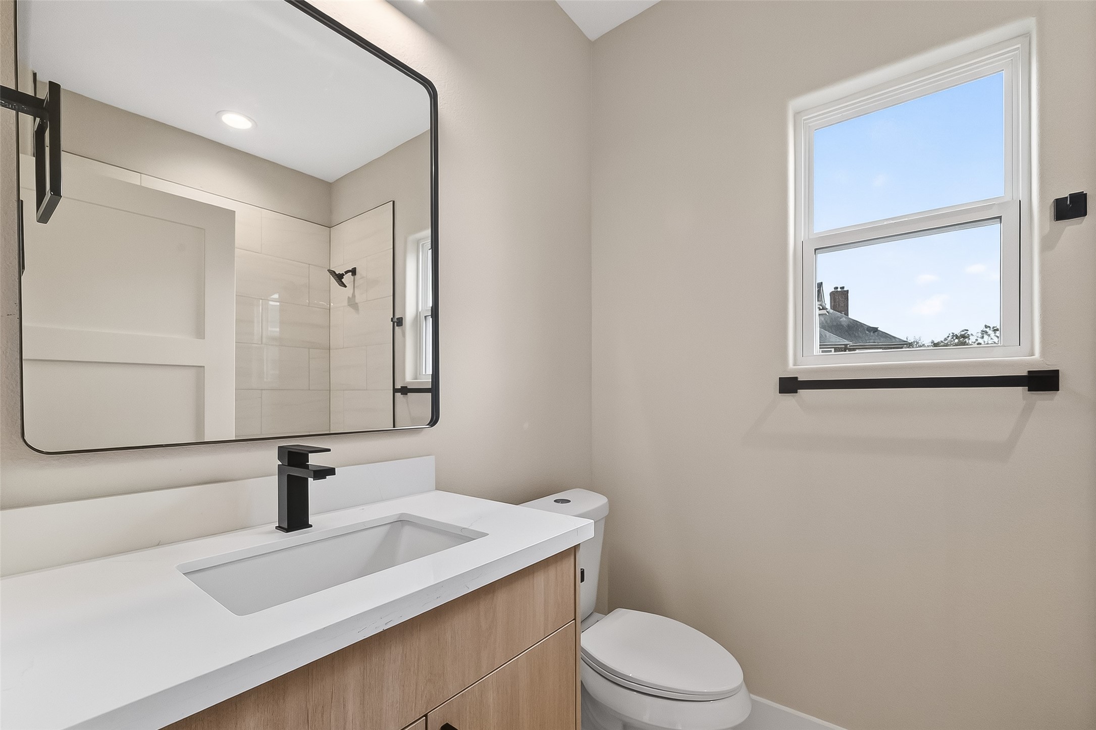 2511 North MacGregor Way Houston, TX 77004 - Photo 12 of 42 a bathroom with a sink a toilet and mirror
