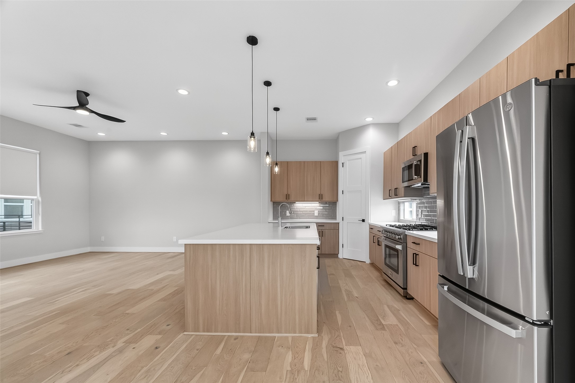 2511 North MacGregor Way Houston, TX 77004 - Photo 20 of 42 a kitchen with stainless steel appliances a refrigerator and a stove top oven
