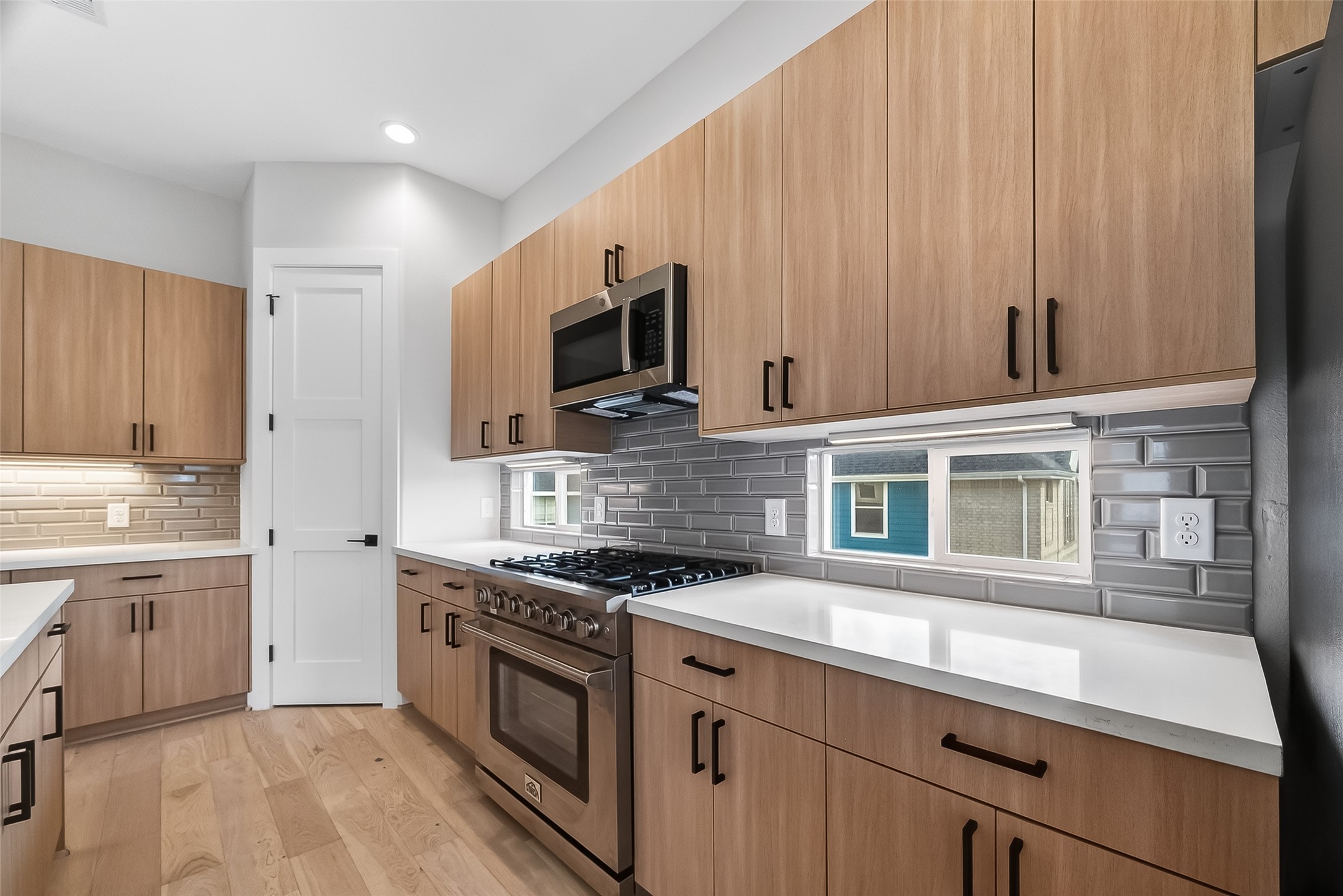 2511 North MacGregor Way Houston, TX 77004 - Photo 22 of 42 a kitchen with stainless steel appliances a sink stove and cabinets