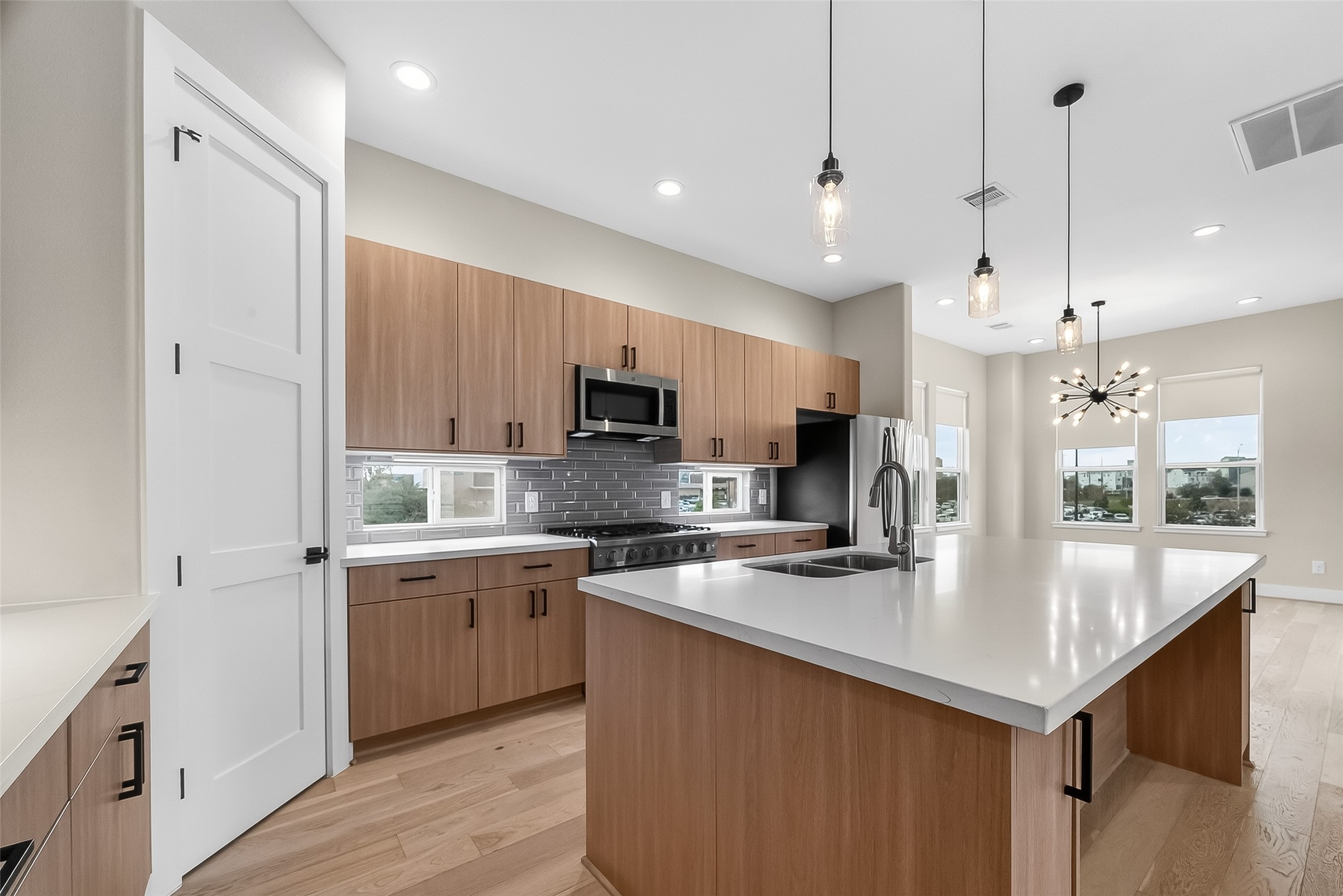 2511 North MacGregor Way Houston, TX 77004 - Photo 24 of 42 a kitchen with stainless steel appliances granite countertop a sink a stove and a refrigerator