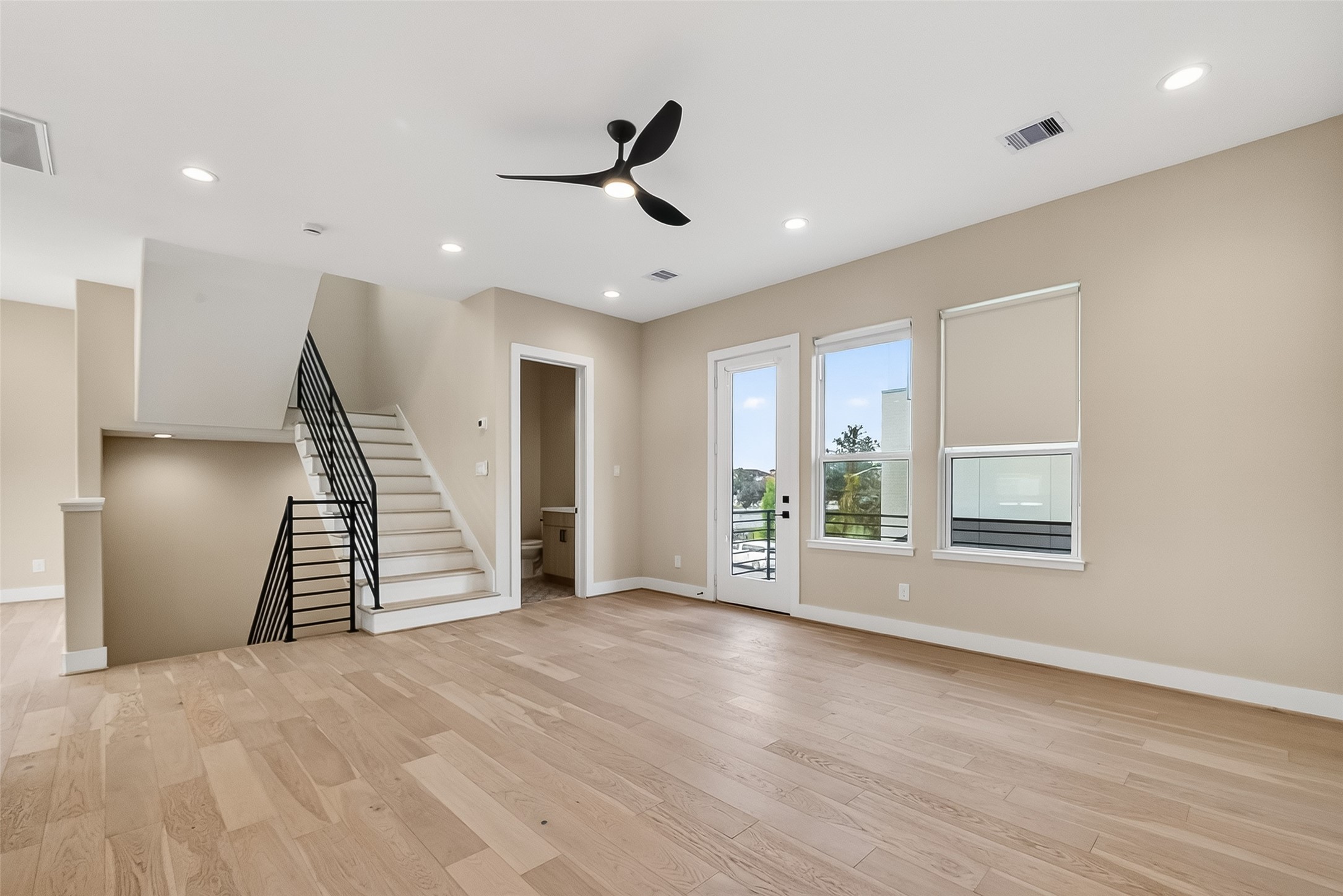 2511 North MacGregor Way Houston, TX 77004 - Photo 25 of 42 a view of an empty room with wooden floor and stairs