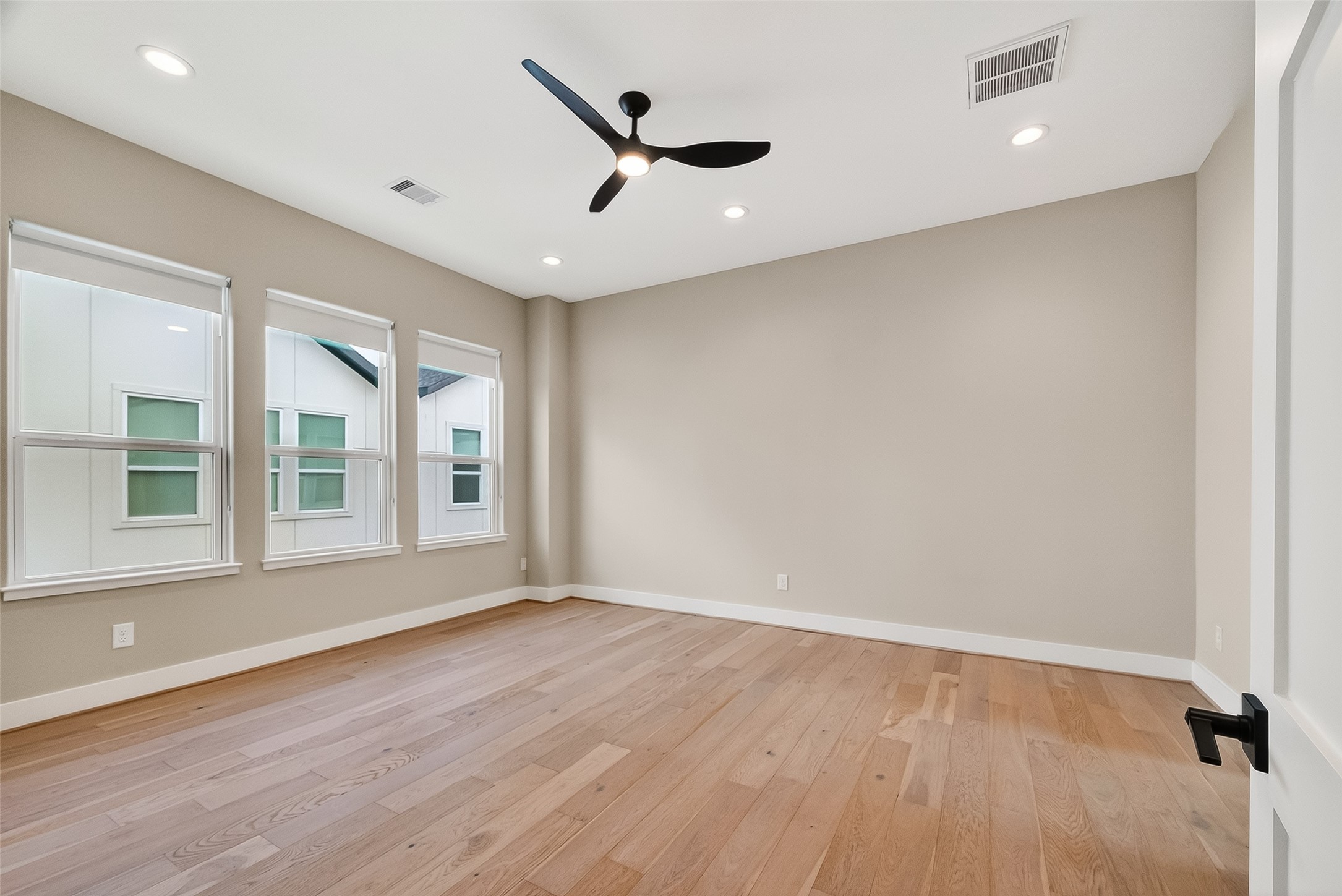 2511 North MacGregor Way Houston, TX 77004 - Photo 35 of 42 an empty room with wooden floor and windows