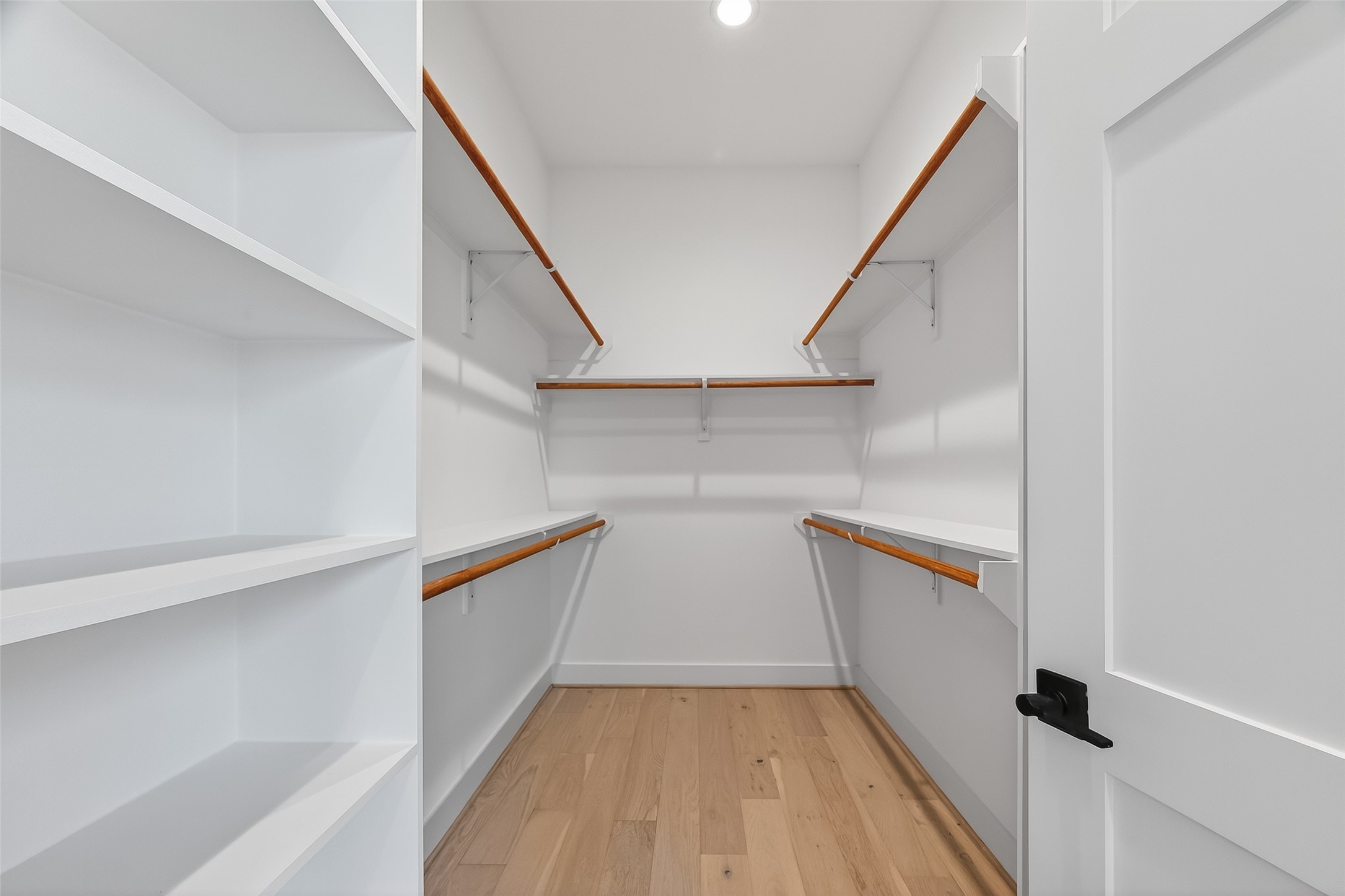 2511 North MacGregor Way Houston, TX 77004 - Photo 37 of 42 Closet featuring built-in shelving for organized storage.