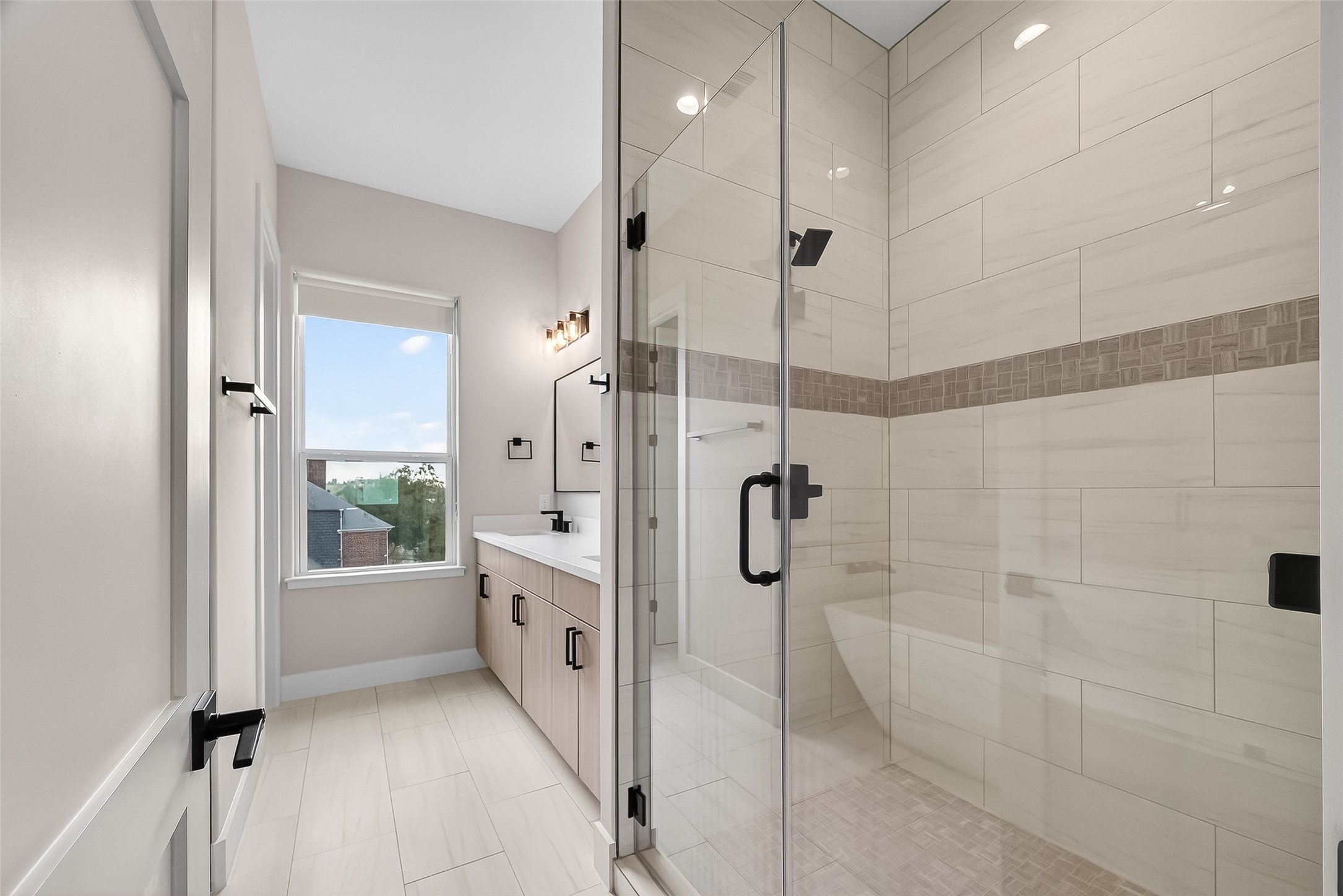 2511 North MacGregor Way Houston, TX 77004 - Photo 38 of 42 a bathroom with a glass shower door