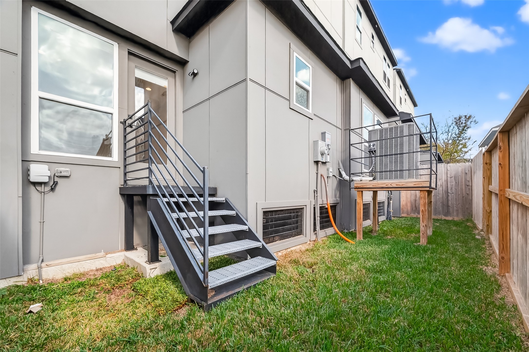 2511 North MacGregor Way Houston, TX 77004 - Photo 42 of 42 a view of a house with wooden stairs and a small yard