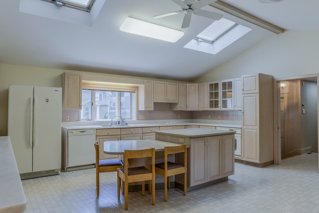16 Audubon Road Lexington, MA 02421 - Photo 12 of 30 a kitchen with stainless steel appliances granite countertop hardwood floor sink stove and refrigerator