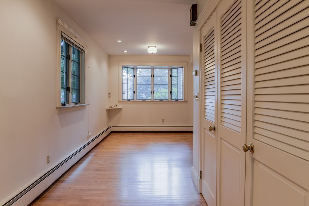 16 Audubon Road Lexington, MA 02421 - Photo 14 of 30 a view of an empty room with wooden floor and a window