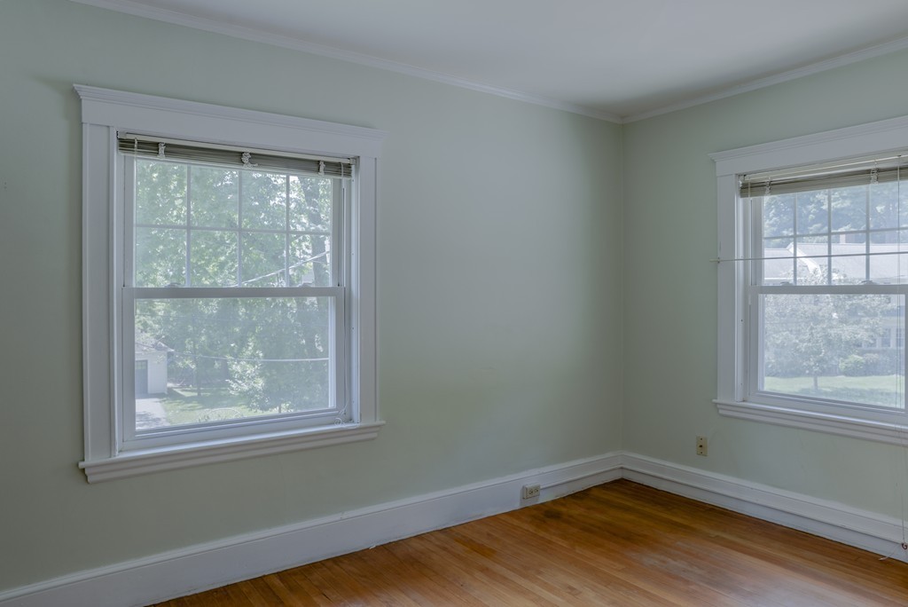 16 Audubon Road Lexington, MA 02421 - Photo 22 of 30 an empty room with wooden floor and windows