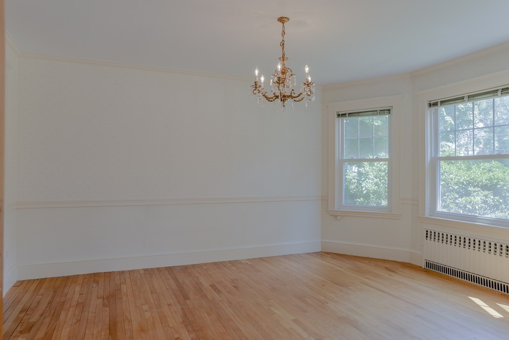 16 Audubon Road Lexington, MA 02421 - Photo 10 of 30 an empty room with wooden floor and windows