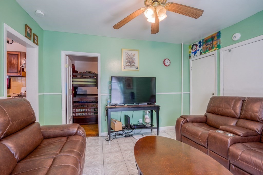 30 Adams Street Springfield, MA 01105 - Photo 12 of 23 a living room with furniture a flat screen tv and a fireplace