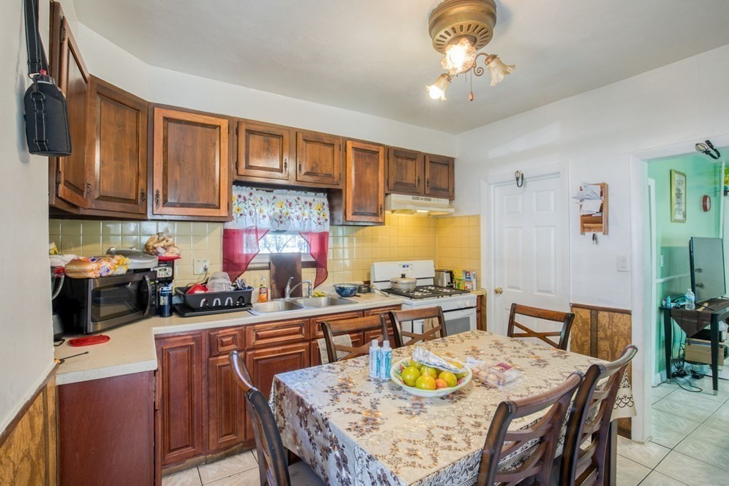 30 Adams Street Springfield, MA 01105 - Photo 16 of 23 a kitchen with a dining table and chairs