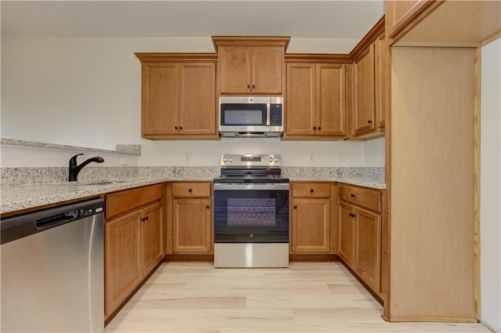 605 Summit Point Canton, GA 30114 - Photo 20 of 56 a kitchen with stainless steel appliances granite countertop a stove a sink and a microwave