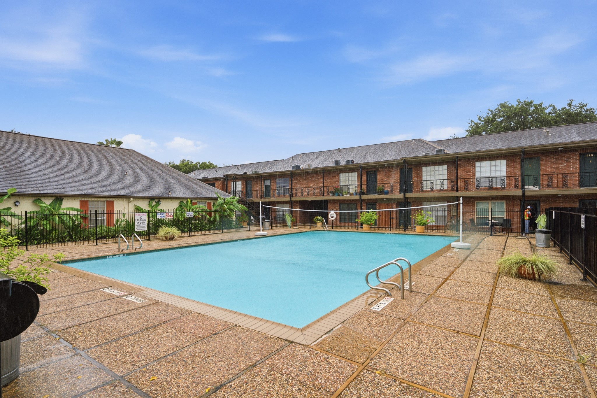 11550 Chimney Rock Road, Unit 133 Houston, TX 77035 - Photo 34 of 40 Enjoy a refreshing swim in the spacious community pool, surrounded by a charming courtyard with well-maintained landscaping and direct access to the inviting residences.