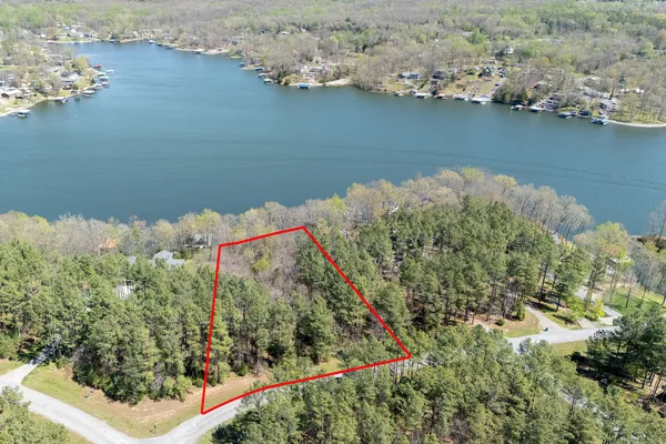 an aerial view of a house with a lake view