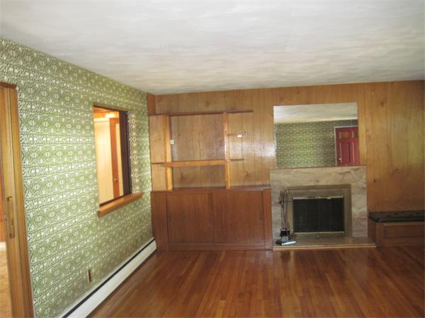 12 Eaton Road Framingham, MA 01701 - Photo 2 of 29 a view of an empty room with wooden floor and a window
