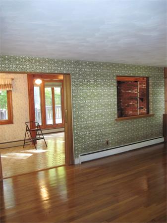 12 Eaton Road Framingham, MA 01701 - Photo 4 of 29 a view of empty room with floor to ceiling window and wooden floor