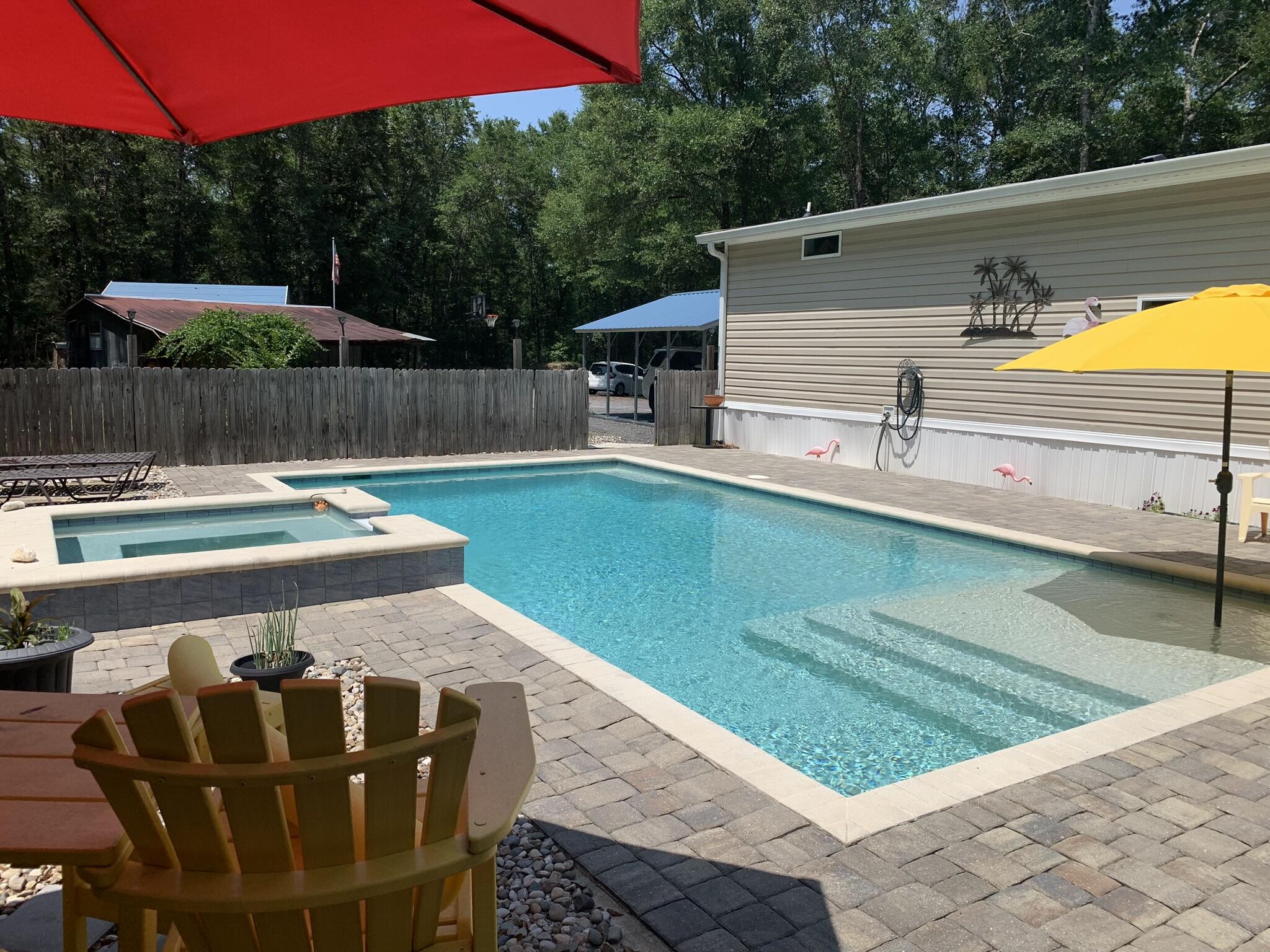a view of a backyard with swimming pool
