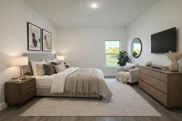 a spacious bedroom with a bed and a flat screen tv