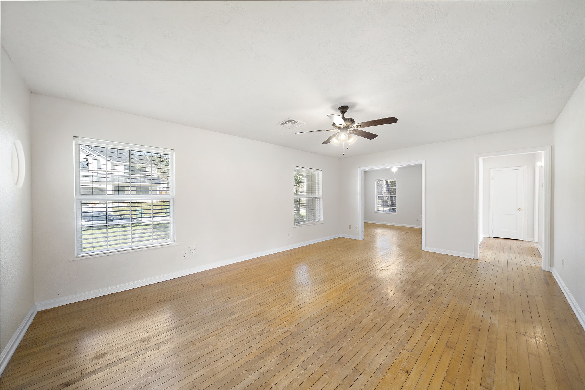 404 Milwaukee Street Houston, TX 77009 - Photo 12 of 19 a view of an empty room with wooden floor and a window