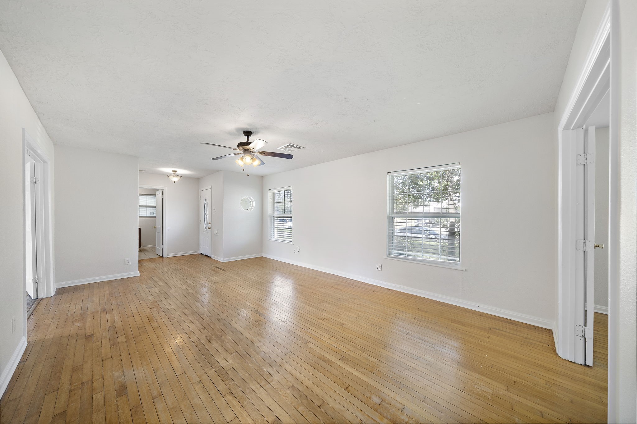 404 Milwaukee Street Houston, TX 77009 - Photo 13 of 19 a view of an empty room with wooden floor and a window