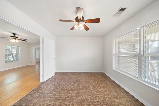 wooden floor in an empty room with a window