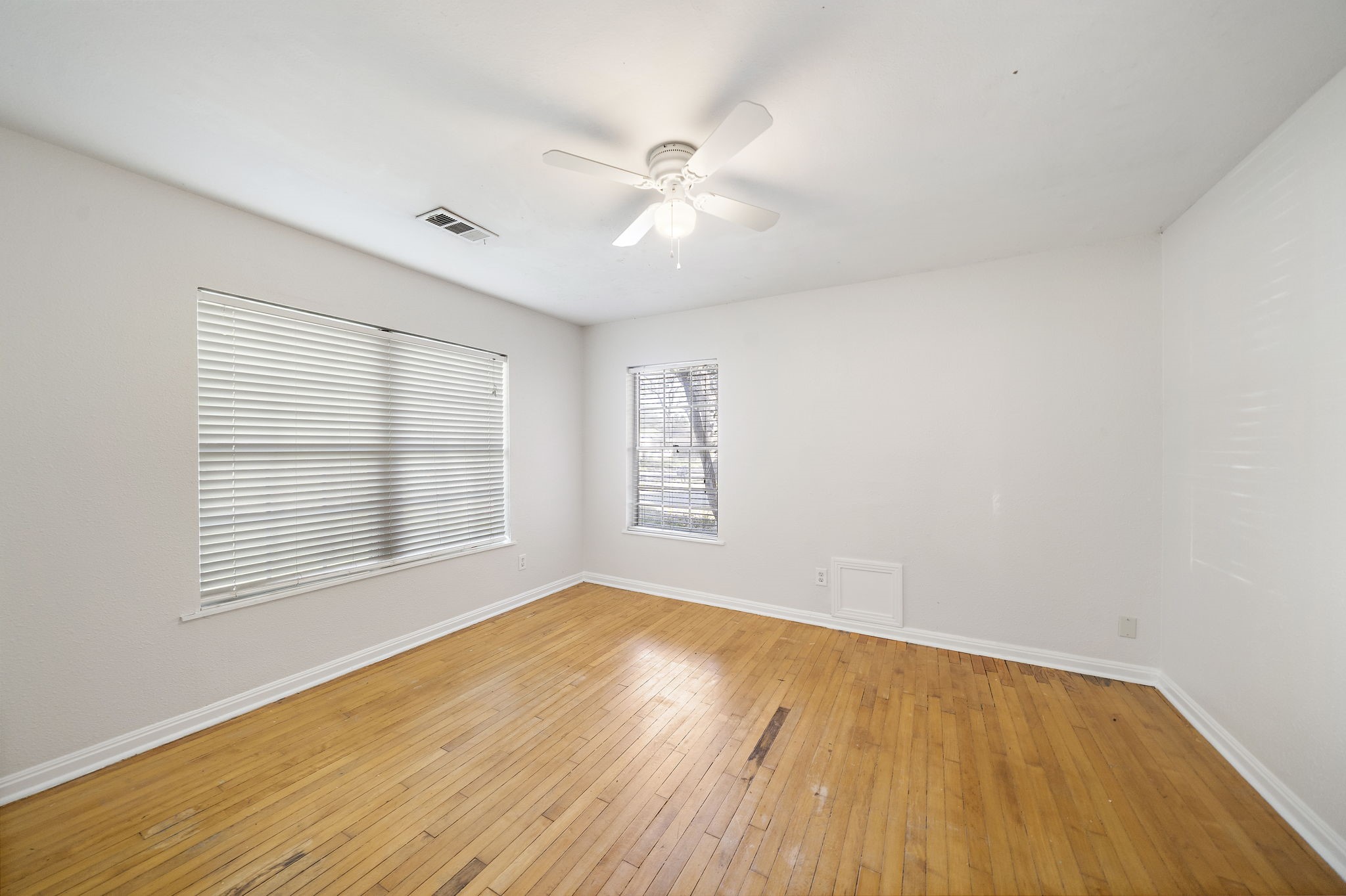 404 Milwaukee Street Houston, TX 77009 - Photo 16 of 19 a view of an empty room with wooden floor and a window